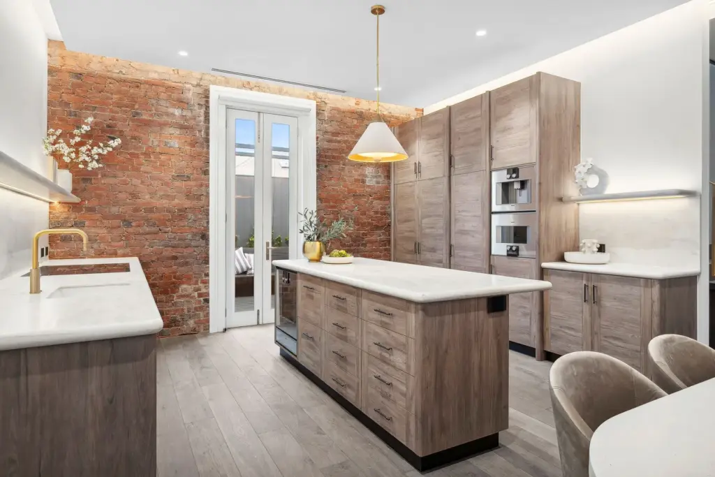 Modern kitchen with brick wall and marble island