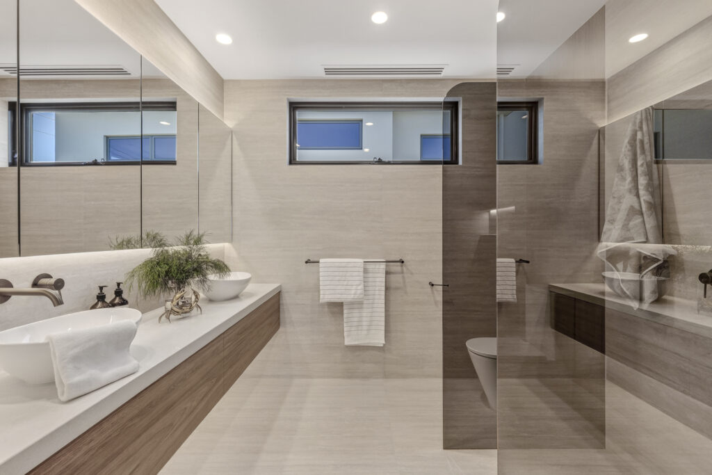 Modern bathroom with double vanity and glass shower