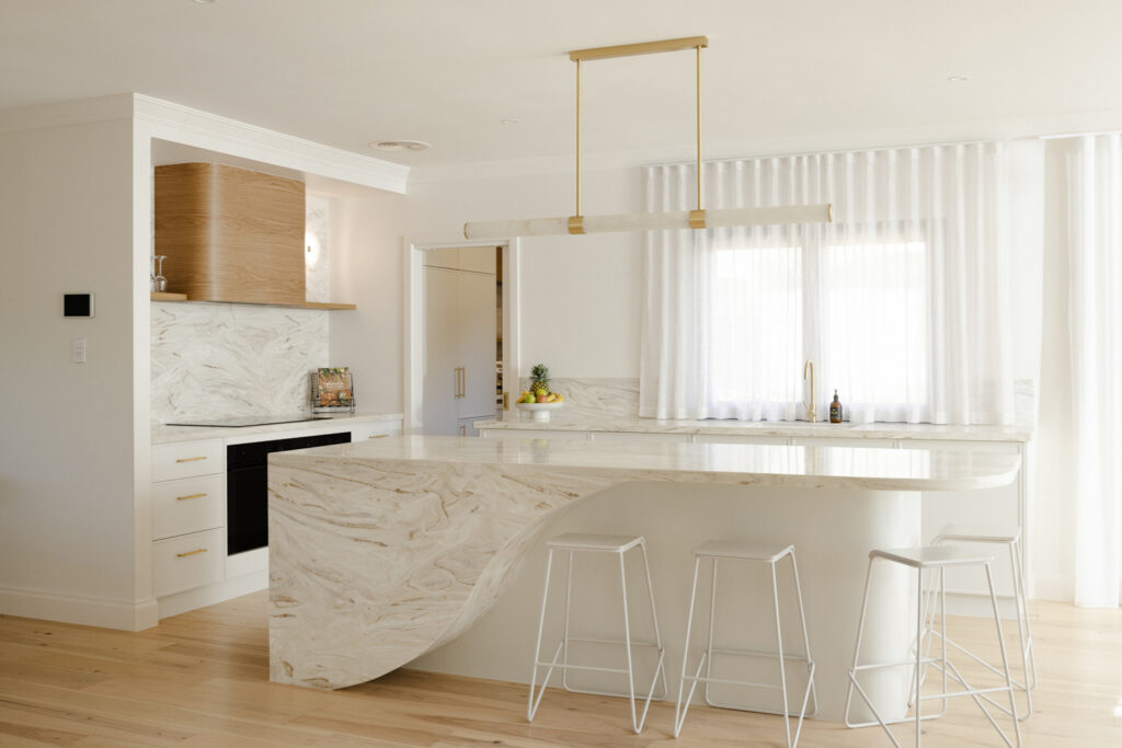 Modern marble kitchen island with white stools