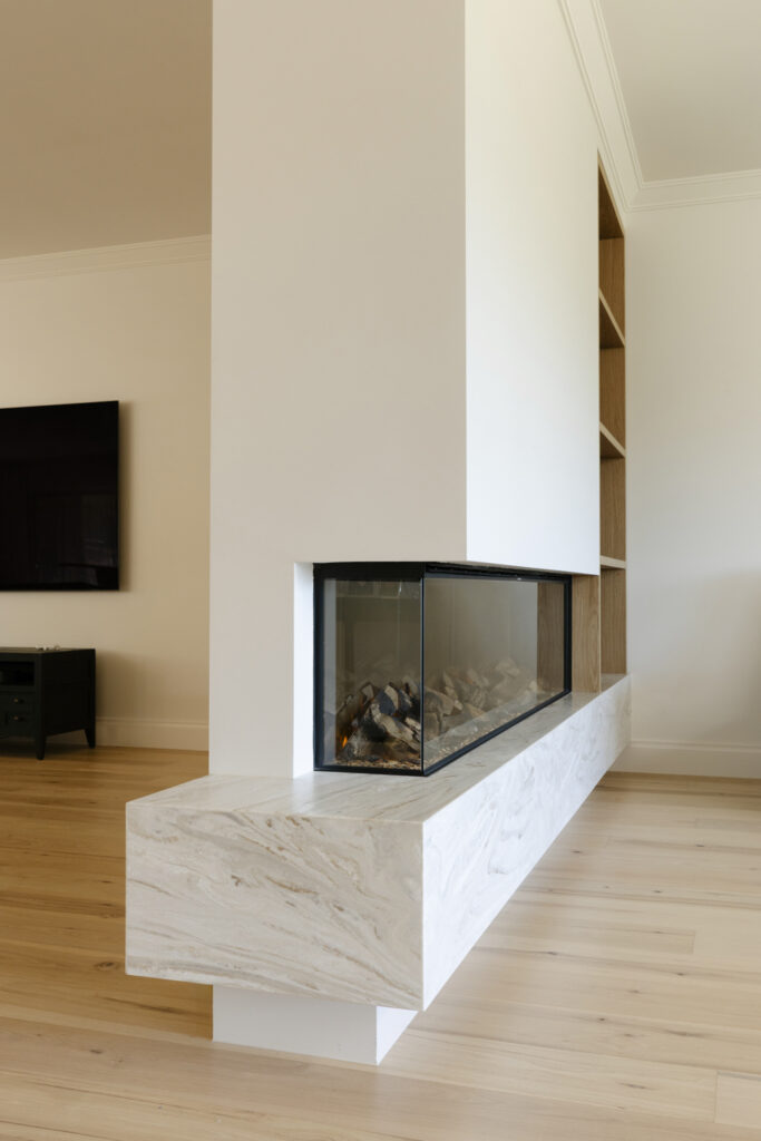 Modern double-sided fireplace with marble hearth